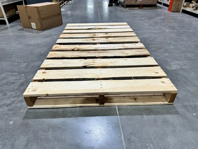 Long custom wooden pallet in warehouse for oversized loads