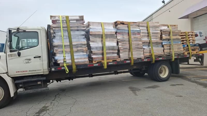 Delivery truck loaded with pallets strapped for transport